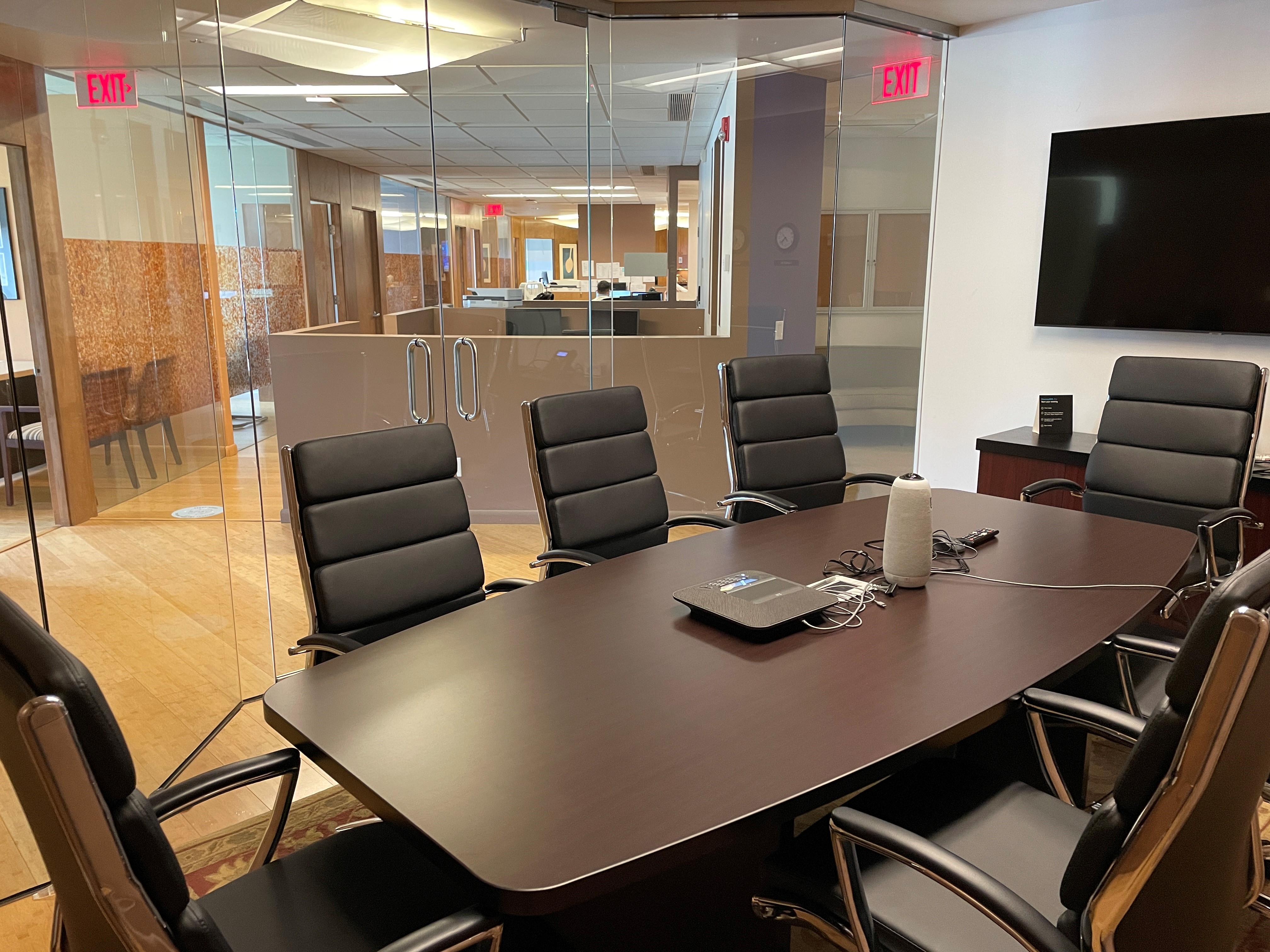 Conference room view with black chairs and glass walls