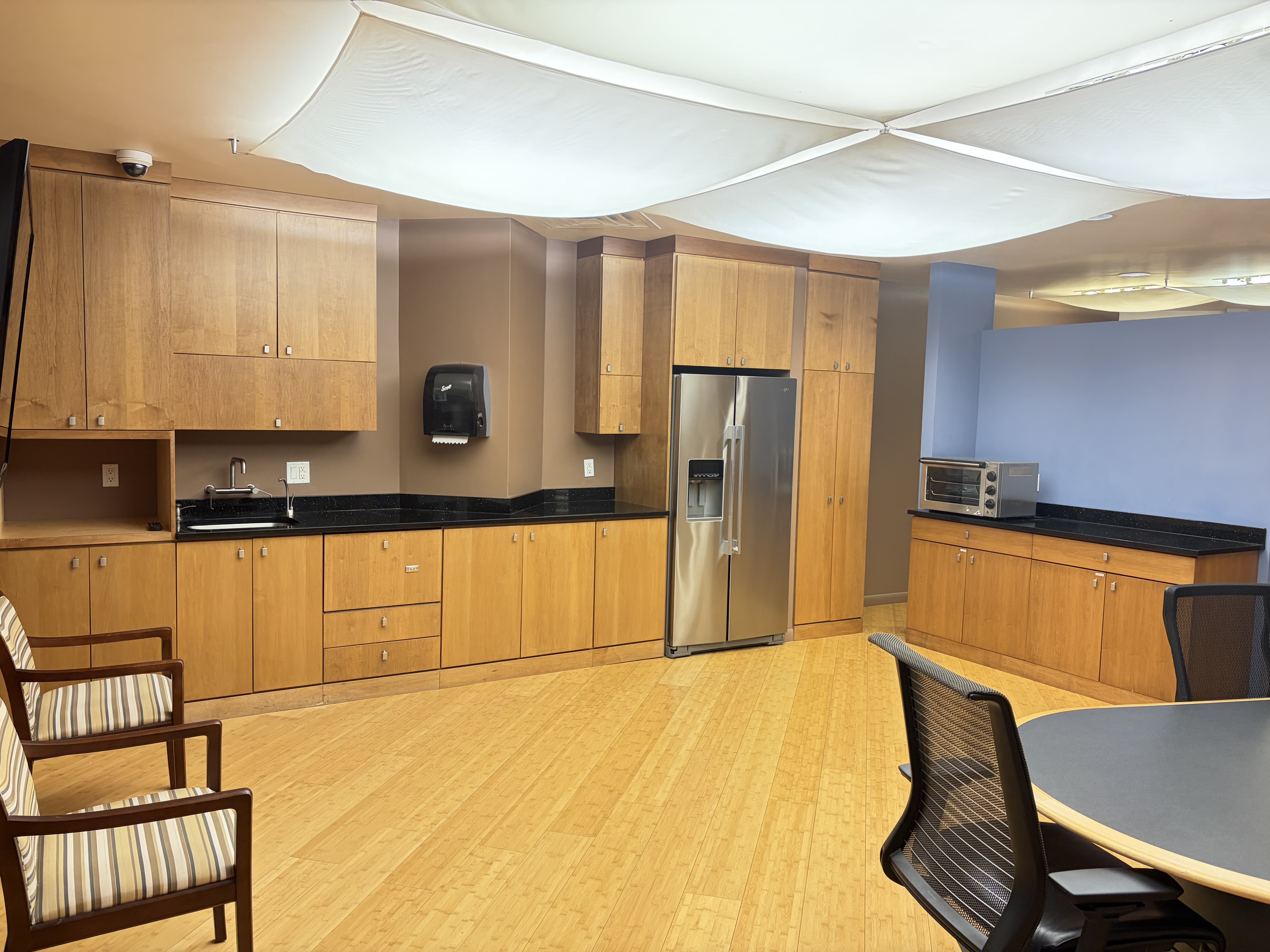 Kitchen and lounge with refrigerator and seating