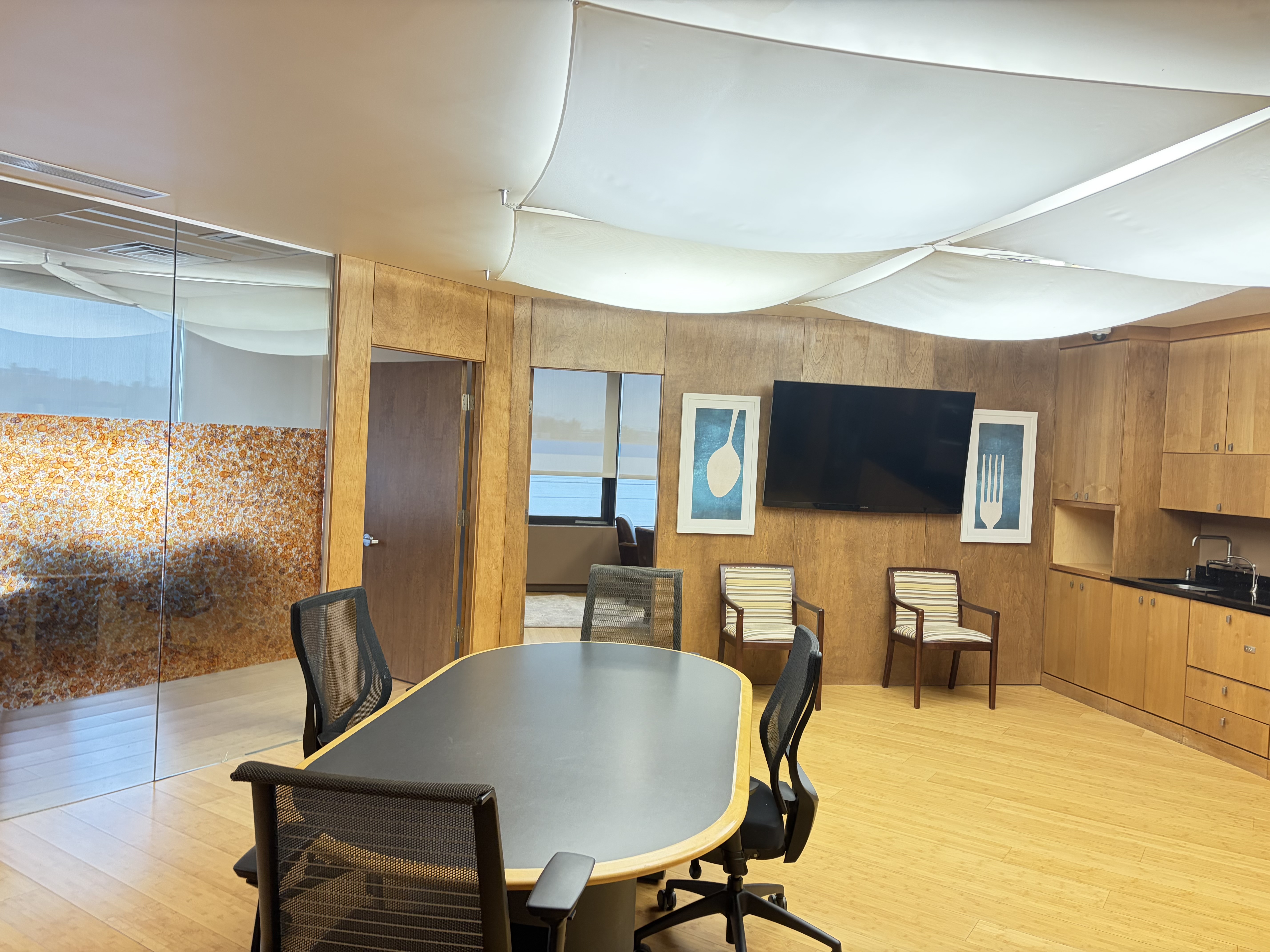 Interior meeting and kitchen area overlapping the exterior photo